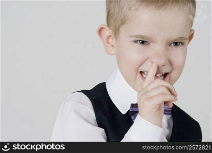 Close-up of a boy with his finger in his nose