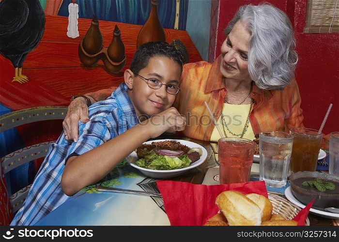 Close-up of a boy with his grandmother in a restaurant