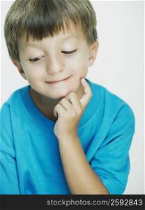 Close-up of a boy with his hand on his chin