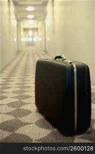 Close-up of a briefcase in the corridor of a hotel