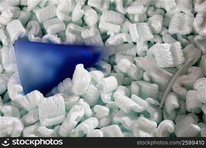 Close-up of a broken vase with packing peanuts