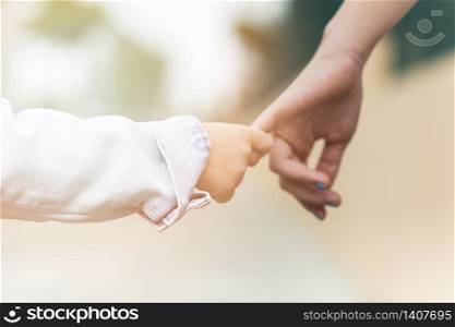 Close-up of a brother holding sister&rsquo;s finger
