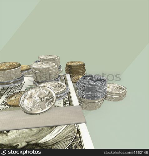 Close-up of a bundle of one hundred dollar bills and stacked coins