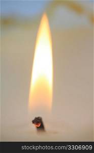 Close up of a burning ivory white candle