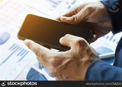 Close up of a business man holding mobile smart phone