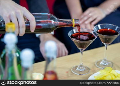 Close up of a business suit of man Pouring champagne into glass on xmas and the new years eve party,Party after work concept