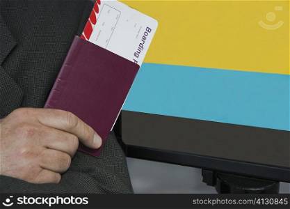 Close-up of a businessman&acute;s hand holding a passport with an airplane ticket