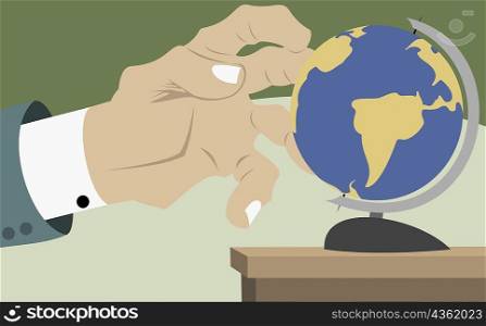 Close-up of a businessman&acute;s hand touching a globe