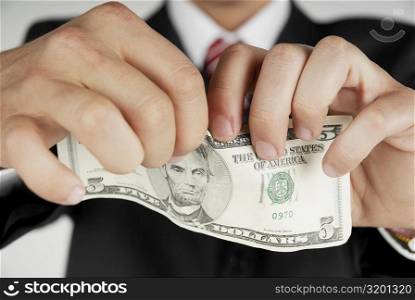Close-up of a businessman&acute;s hands holding an American dollar bill