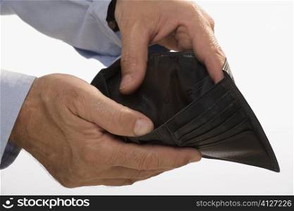 Close-up of a businessman&acute;s hands showing his empty wallet