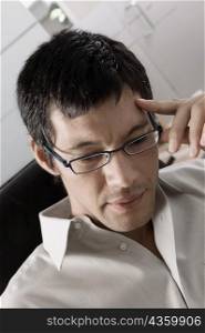 Close-up of a businessman adjusting his eyeglasses