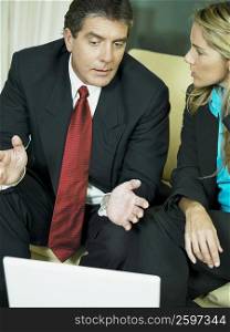 Close-up of a businessman and a businesswoman discussing