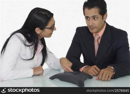 Close-up of a businessman and a businesswoman discussing in a boardroom