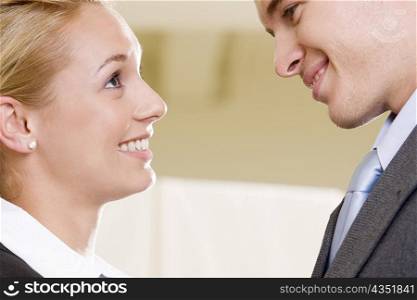 Close-up of a businessman and a businesswoman face to face