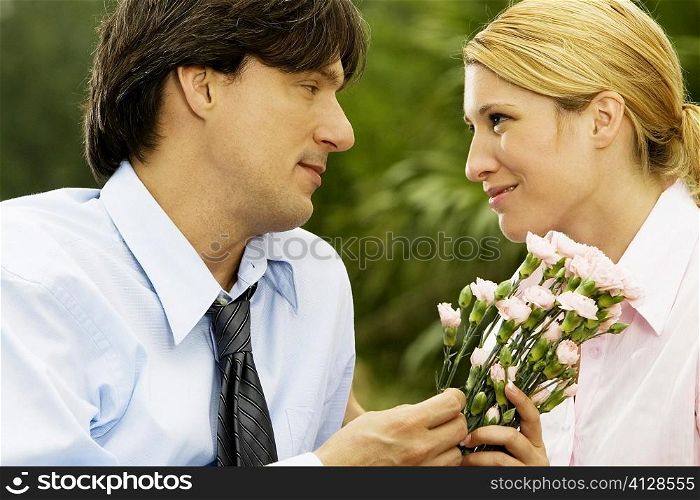 Close-up of a businessman and a businesswoman looking at each other