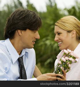 Close-up of a businessman and a businesswoman looking at each other in the park
