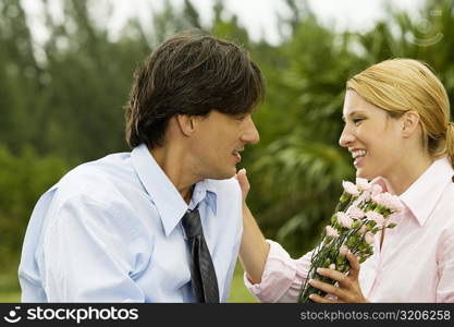 Close-up of a businessman and a businesswoman looking at each other in the park