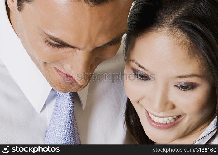 Close-up of a businessman and a businesswoman looking down