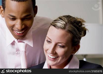 Close-up of a businessman and a businesswoman smiling