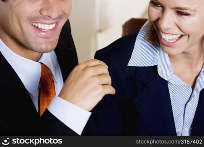 Close-up of a businessman and a businesswoman smiling