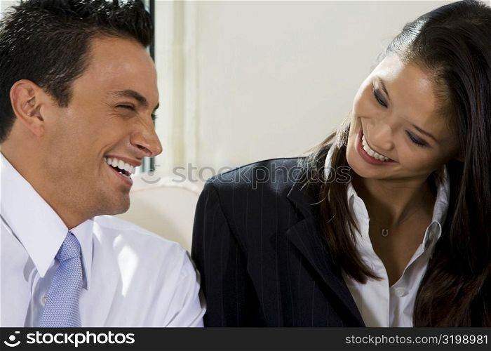 Close-up of a businessman and a businesswoman smiling