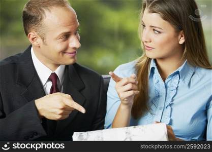 Close-up of a businessman and a teenage girl looking at each other