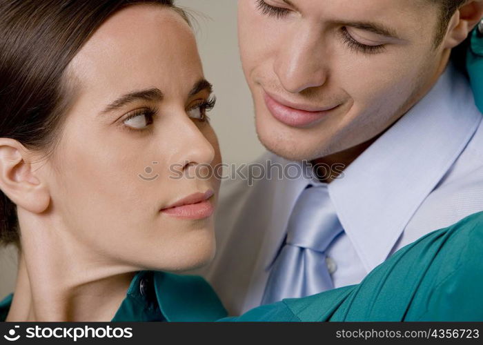 Close-up of a businessman and businesswoman looking at each other