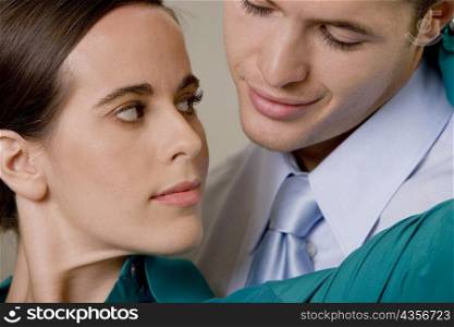 Close-up of a businessman and businesswoman looking at each other