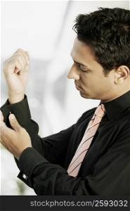 Close-up of a businessman buttoning his cuff