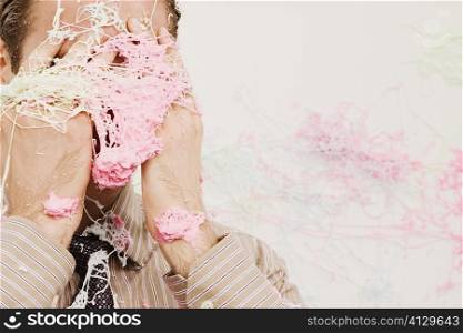 Close-up of a businessman covered with silly string