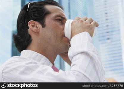 Close-up of a businessman drinking cold drink
