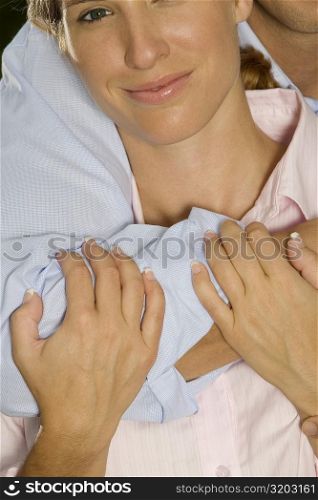 Close-up of a businessman embracing a businesswoman