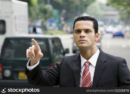 Close-up of a businessman hailing for a vehicle