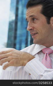 Close-up of a businessman holding a disposable cup