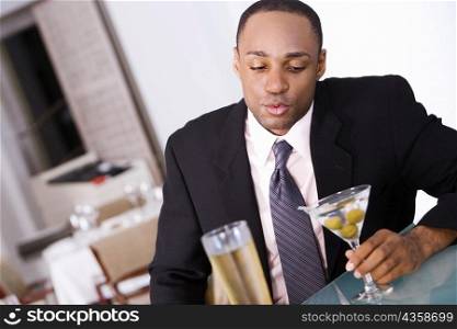 Close-up of a businessman holding a glass of martini