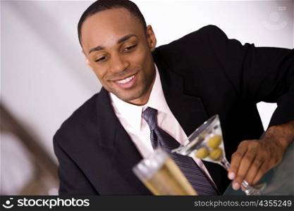 Close-up of a businessman holding a glass of wine