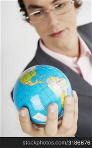 Close-up of a businessman holding a globe