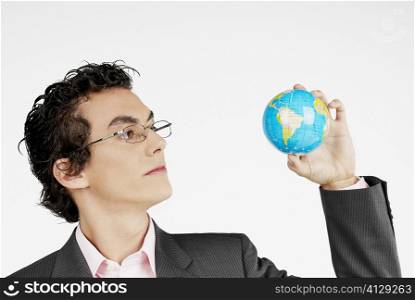 Close-up of a businessman holding a globe