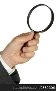 Close-up of a businessman holding a magnifying glass