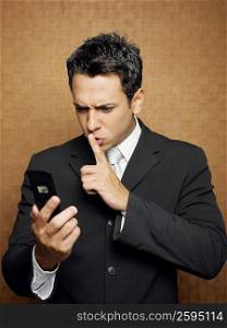 Close-up of a businessman holding a mobile phone and gesturing