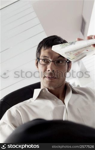 Close-up of a businessman holding a newspaper