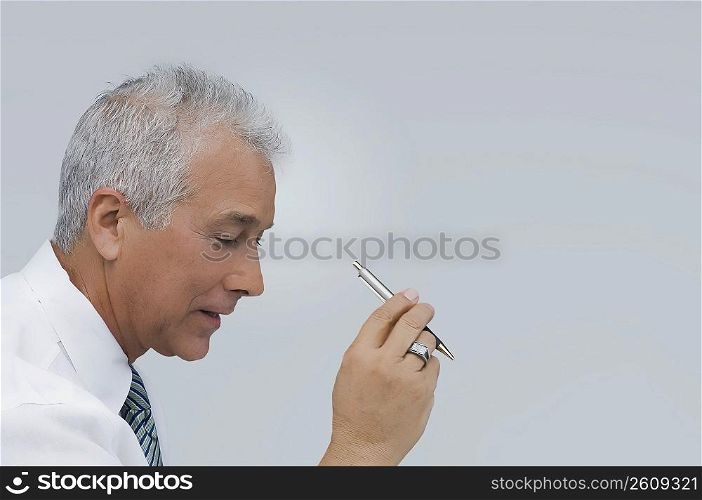 Close-up of a businessman holding a pen