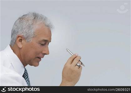 Close-up of a businessman holding a pen