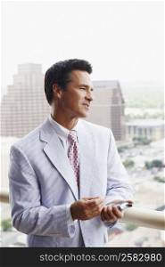 Close-up of a businessman holding a personal data assistant