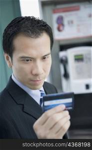 Close-up of a businessman holding a phone card