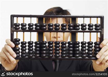 Close-up of a businessman holding an abacus