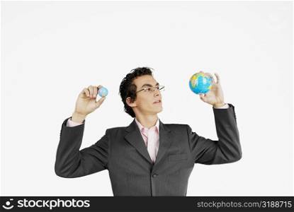 Close-up of a businessman holding globes
