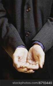 Close-up of a businessman holding out his hands