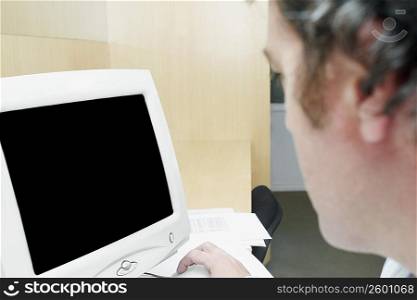 Close-up of a businessman in front of a computer