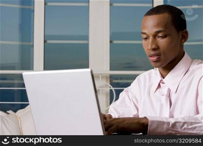 Close-up of a businessman in front of a laptop